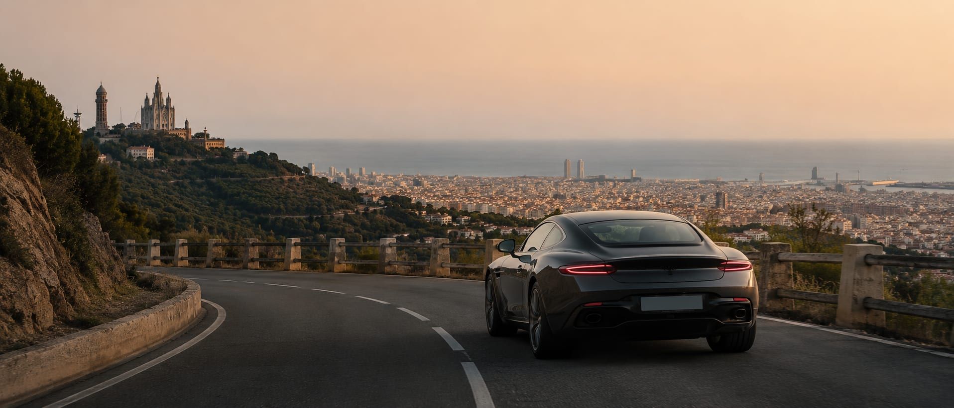 A coastal road leaving Barcelona toward the Costa Brava under clear light.