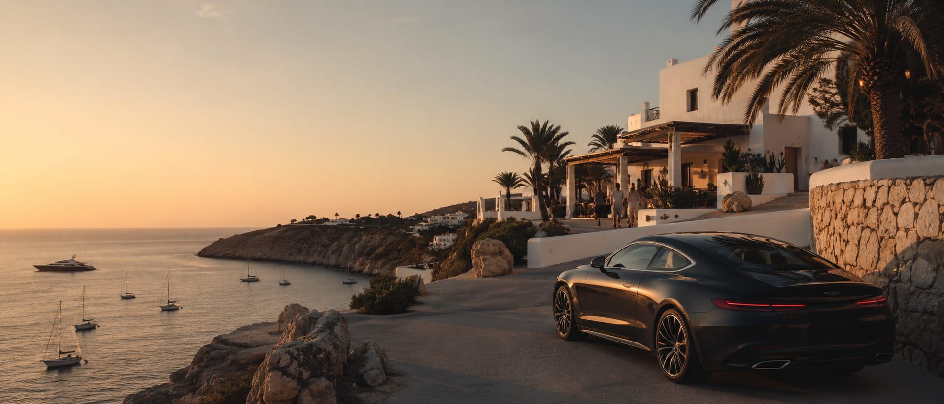 An open-top car prepared outside an Ibiza villa at the start of a summer-season day, the island hills and sea beyond.