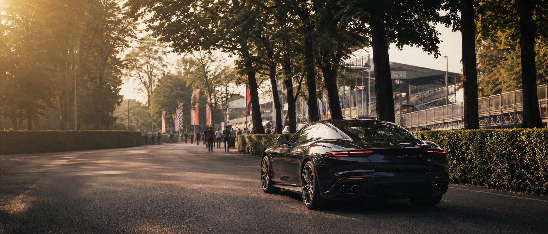 A grand tourer prepared on a quiet road near Monza on Italian Grand Prix weekend, the Parco di Monza woodland beyond.