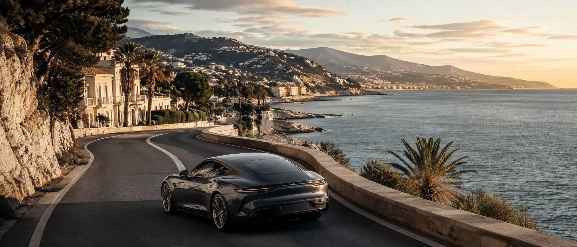 A coastal corniche road above the sea east of Nice in clear light.